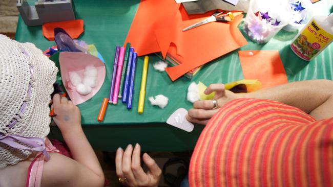 Children making various Christmas craft items.