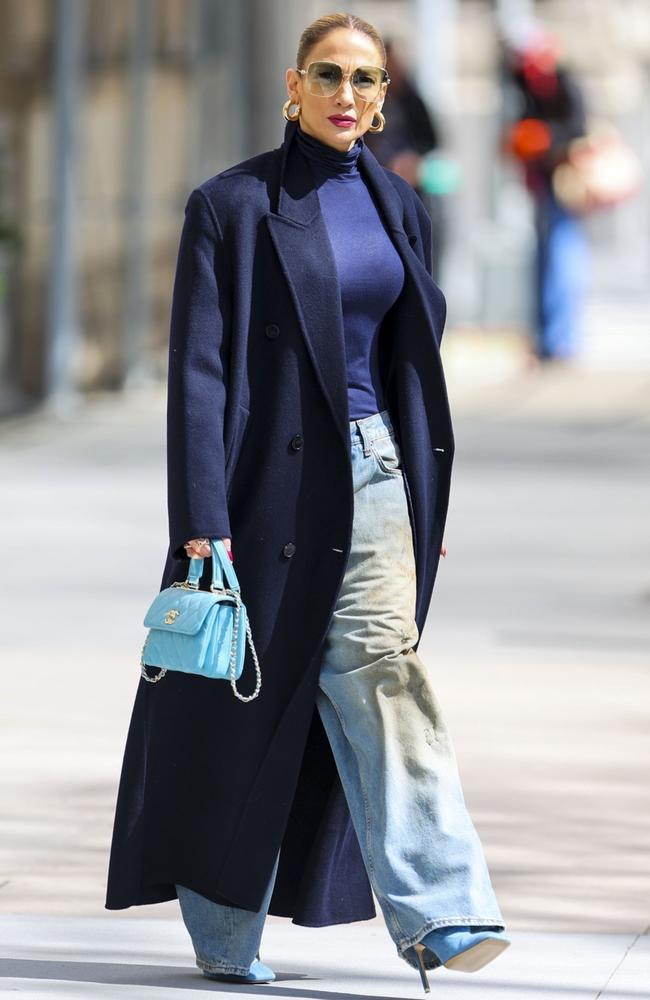 Ooph, Jennifer Lopez is pulling off a look here. Layering four shades of blue, she teamed an oversized navy coat with a slightly lighter coloured Intimissimi turtleneck, faded blue wide-leg jeans by Acne Studios that grazed the ground and baby blue heels. And it works! Picture: BACKGRID Australia <br/>