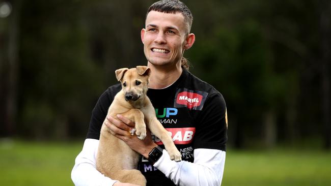 GAP NSW ambassador Harry Garside with "Alice " a greyhound puppy