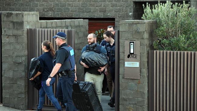 Police carry out bags of items from John Ibrahim’s home at Dover Heights. Picture: Richard Dobson