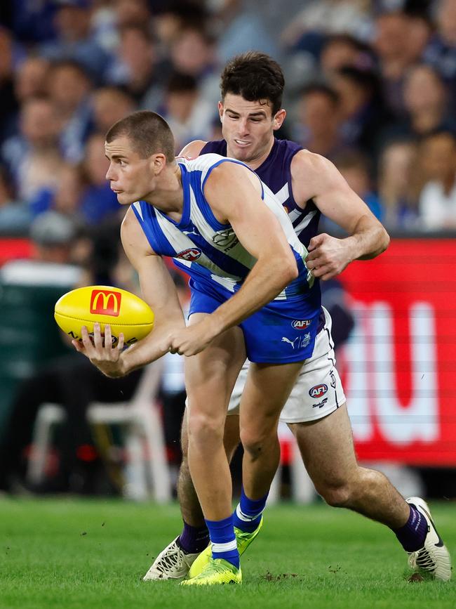 Bailey Scott of the Kangaroos tries to evade Andrew Brayshaw of the Dockers at Marvel Stadium on Saturday. Picture: Dylan Burns/AFL Photos via Getty Images.