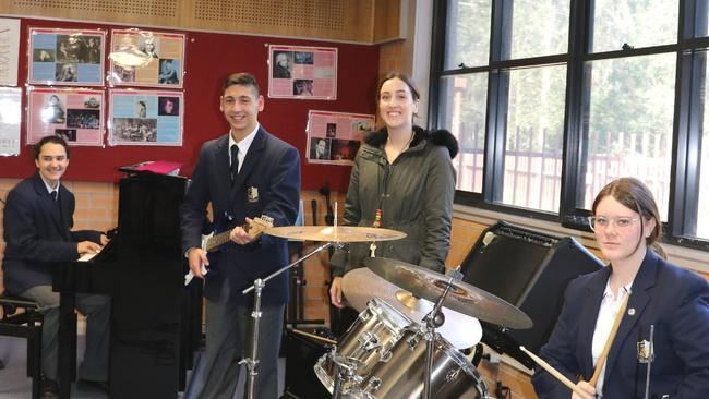 Music teacher Abbey Baker with her students.