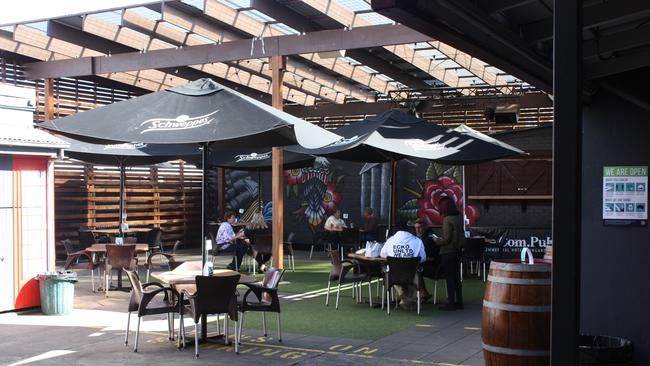 Patrons enjoying a meal in the Commercial Hotel beer garden.