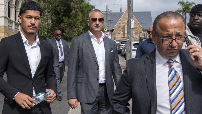 SYDNEY AUSTRALIA - NewsWire Photos, 11 DECEMBER, 2023: St George Illawarra Dragons player, Talatau Amone (dark suit) charged over his role in an alleged rooftop hammer attack leave Wollongong Court before sentencing.Picture: NCA NewsWire / Simon Bullard.