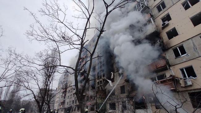 Rescuers work next to a residential building damaged by shelling, as Russia's attack on Ukraine continues, in Kyiv, Ukraine. Picture: Reuters