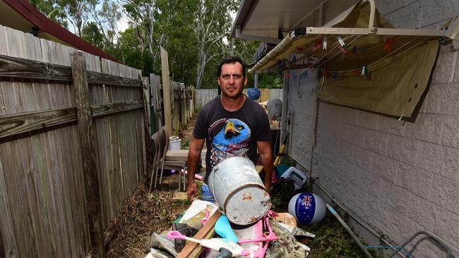 Flooding in Laura Court, Deeragun. Daniel Hanran clears water damaged items from his house. Picture: Evan Morgan