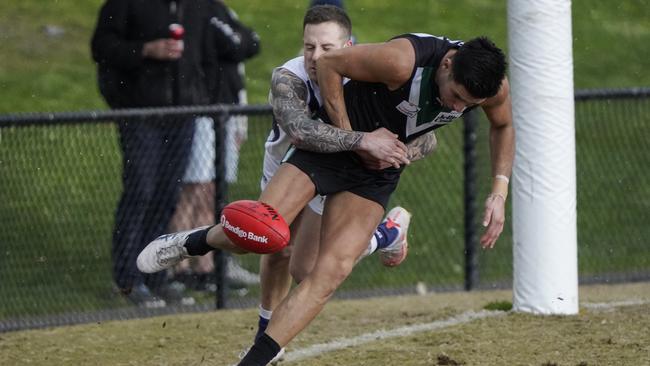 EFL: Donvale’s Ethan Duncan has the ball stripped by Daniel Versteegen of Coldstream. Picture: Valeriu Campan