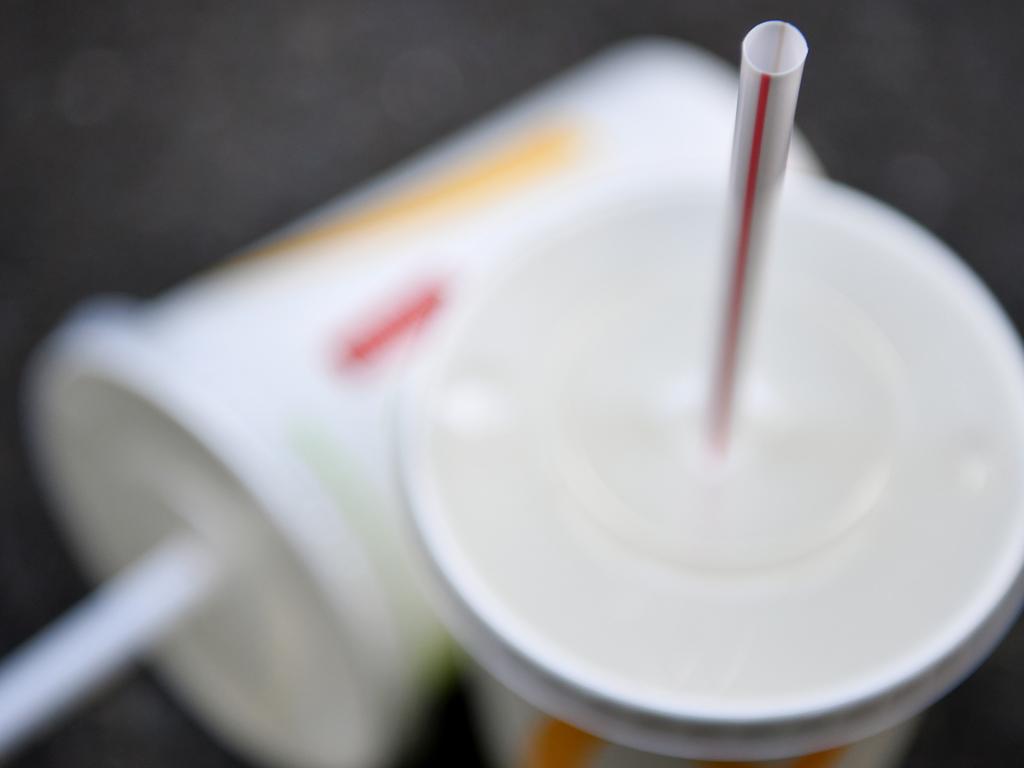 A McDonald's cup and plastic straw in Sydney, Wednesday, July 18, 2018. Fast food chain McDonald's will trial paper straws next month, with the long-term plan set to be rolled out at all 970 restaurants around Australia by 2020. (AAP Image/Joel Carrett) NO ARCHIVING