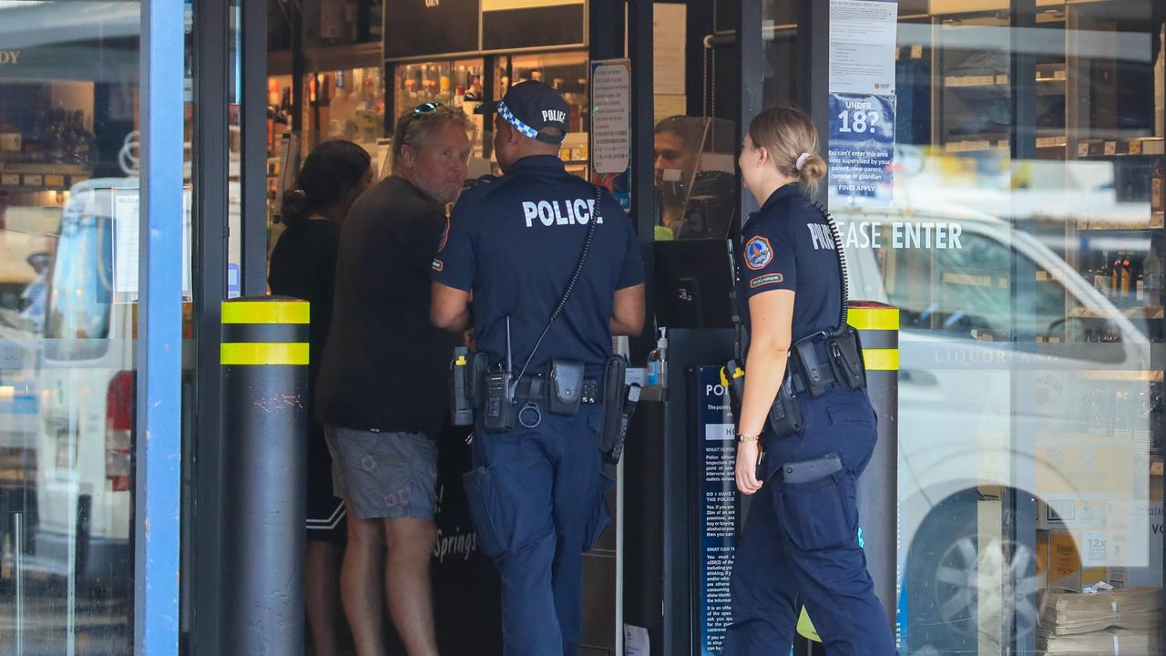 Two police officers stationed outside a busy Liquorland in Alice Springs asked customers five questions before they entered the store. Picture: JPL/Media Mode/news.com.au