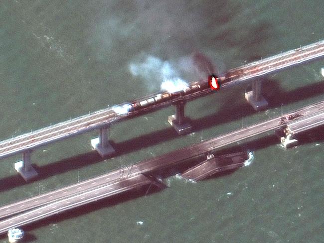 This handout satellite image shows smoke billowing from a fire on Kerch Bridge that links Crimea to Russia, after a truck exploded. Picture: AFP/HO/Maxar Technologies