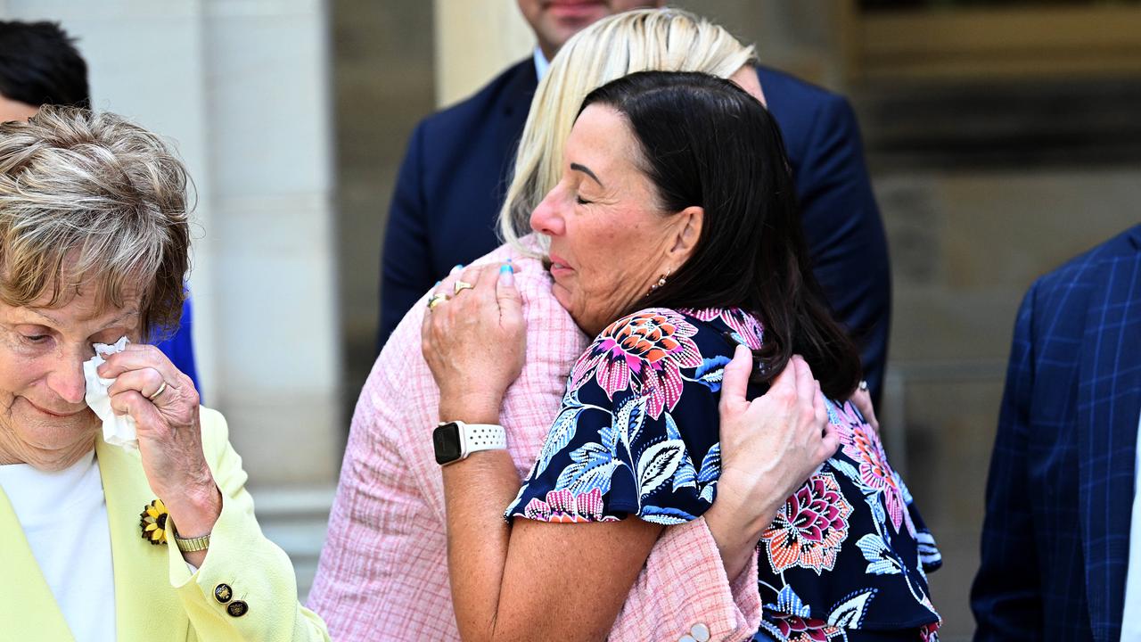 Queensland Acting Attorney-General Shannon Fentiman hugs Sue Clarke, mother of murdered woman Hannah Clarke as Priscilla Dickie, mother of murdered woman Allison Baden Clay wipes a tear, after the passing of a coercive control legislation. Picture: Dan Peled / NCA NewsWire