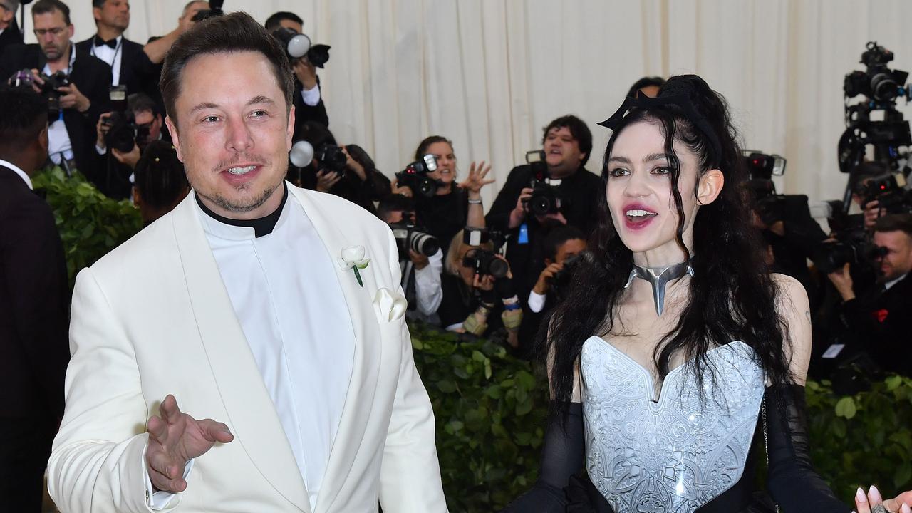 The world’s richest man Elon Musk (above with his then-girlfriend, musician Grimes in 2018) has poked fun at himself, including the name they chose for their son, X Æ A-12. Picture: Angela Weiss/AFP