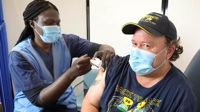 At the ‘Super Walk-In Weekend’ at Elizabeth, registered nurse Atong Ather gives Darren Thompson of Salisbury his second Pfizer dose. Picture: Dean Martin