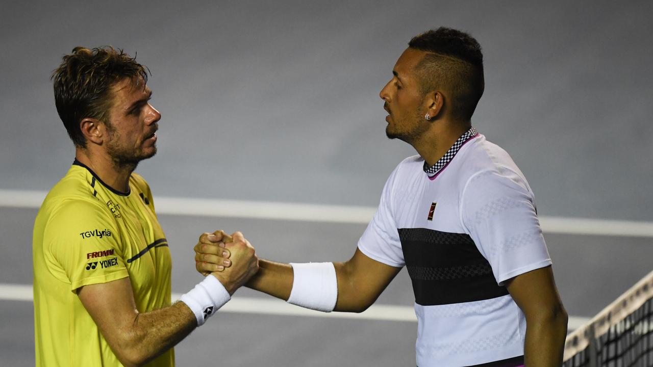 Australian tennis player Nick Kyrgios shakes hands with Swiss tennis player Stan Wawrinka in 2019. Photo by PEDRO PARDO / AFP.