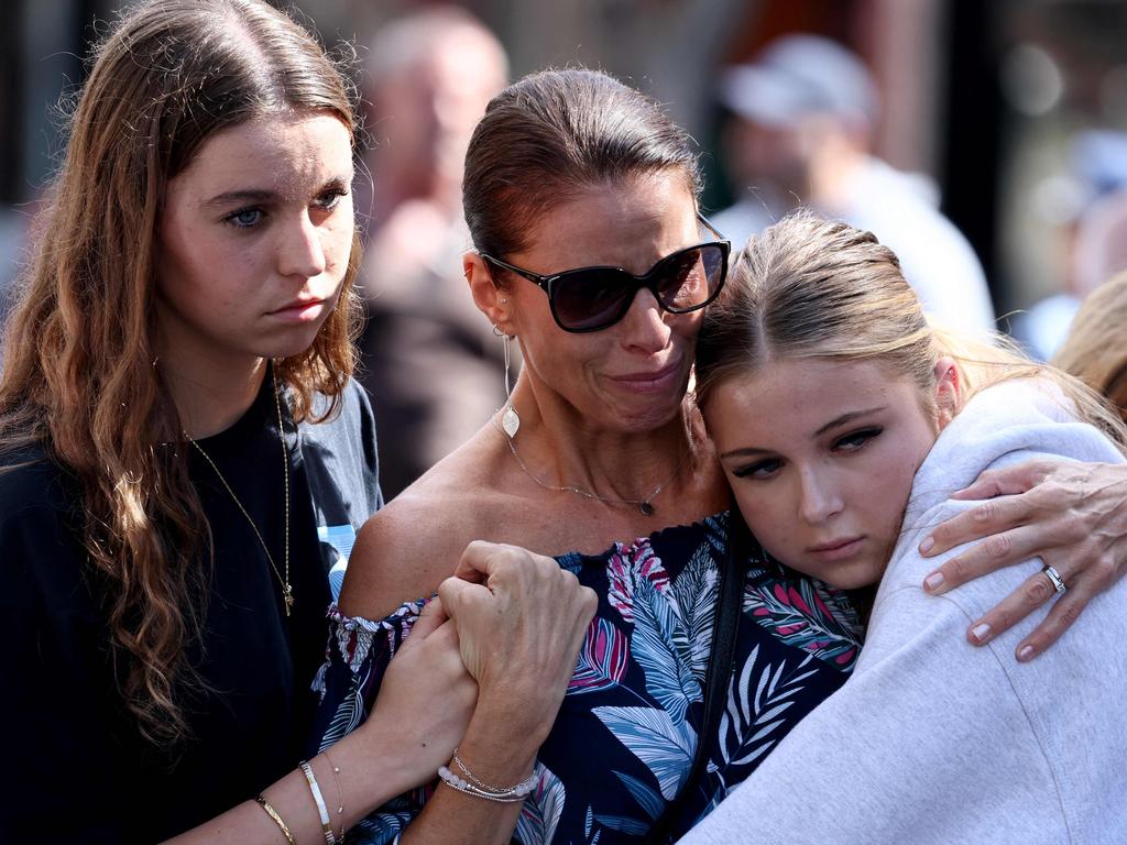 People react outside the Westfield Bondi Junction shopping mall. Picture: David Gray/AFP