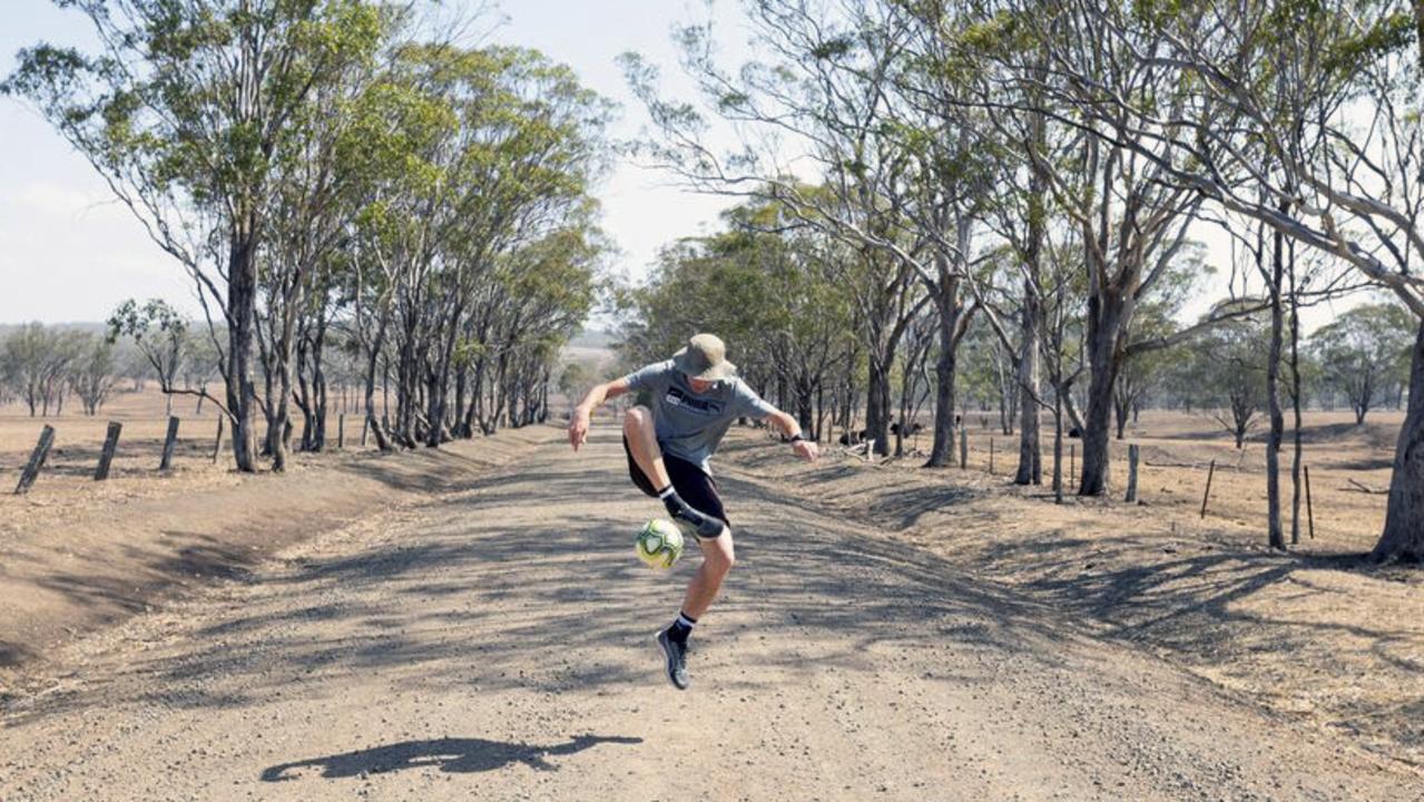 Jed Hockin jumps with a soccer ball in Toowoomba, Qld. Picture: Lucas Carberry via AP