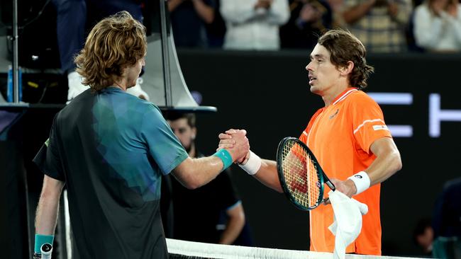 Andrey Rublev (L) embraces Alex de Minaur of Australia after winning his round four singles match. (Photo by Julian Finney/Getty Images)