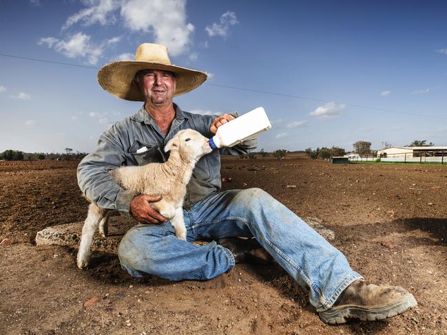 HOLD SEE COURIER MAIL PIC DESKWestern Queensland Grazier Will Roberts bottle feeding one of his poddy lambs on his drought hit property north east of Charleville. 'Every drought breaks but its a farmers job to be absolutely ready when it does', Will takes a positive and proactive approach to surviving the drought, cutting his stock back to a high quality core as well as making sure his 80,000 acre property is prepared to make the most of every drop of rain that comes Photo Lachie Millard