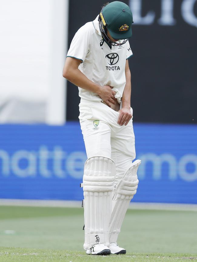 Sam Konstas checks the damage after copping a ball in the groin. Picture: Michael Klein