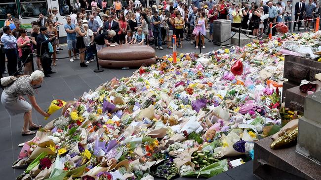 The growing floral tribute on the corner of Bourke and Elizabeth streets. Picture: Nicole Garmston