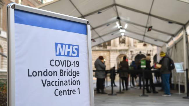 People queue at an NHS Covid-19 vaccination centre for the Pfizer-BioNTech vaccine in London. Picture: AFP