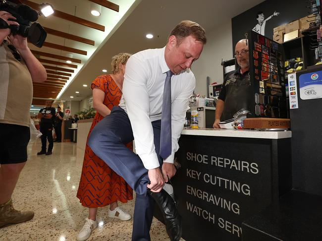 Queensland Premier Steven Miles getting his shoes cleaned in Mackay. Picture: Adam Head