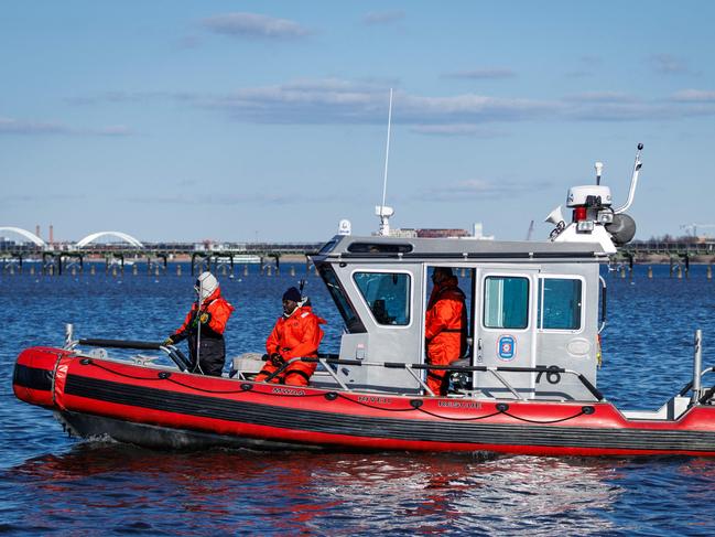 WASHINGTON, DC - FEBRUARY 1: A D.C. Fire River Rescue craft patrols the shores of the Potomac River near the crash site of the U.S. Army Black Hawk helicopter and American Airlines Flight 5342 on February 1, 2025 in Washington, DC. An American Airlines flight from Wichita, Kansas collided midair with a military Black Hawk helicopter while on approach to Ronald Reagan Washington National Airport on January 29th. According to reports, there were no survivors among the 67 people on both aircraft.   Samuel Corum/Getty Images/AFP (Photo by Samuel Corum / GETTY IMAGES NORTH AMERICA / Getty Images via AFP)