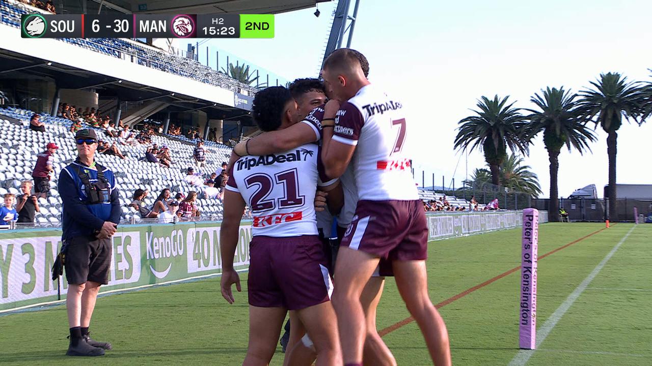 Manly players celebrate a try in their trial game.