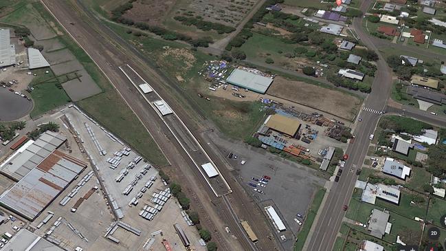 Holmview train station in the centre of the photo with its current car park abutting a glass making business with Logan River Tree Farm at the top of the photo.