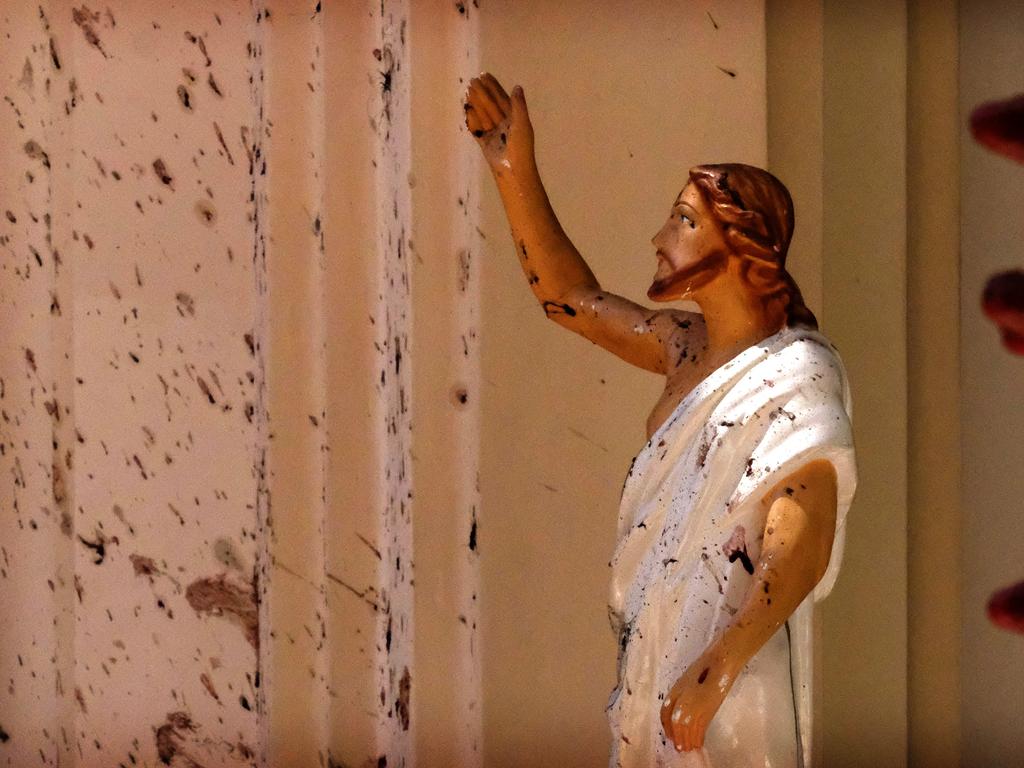 Blood stains are seen on the wall and on a Jesus Christ statue at the St. Sebastian's Church. Picture: AP