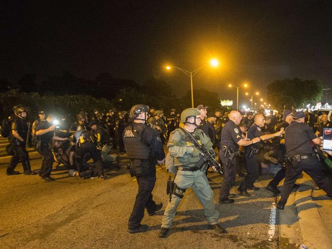 Baton Rouge police rush the crowd of protesters and start making arrests on Saturday. Picture: Mark Wallheiser