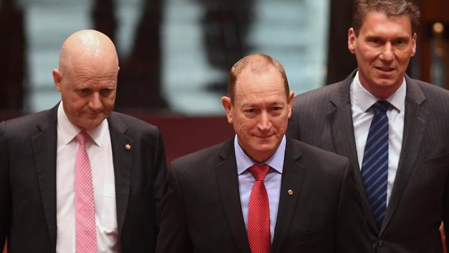 Queensland Senator Fraser Anning (centre), arriving in the Senate to be sworn in, with senators David Leyonhjelm and Cory Bernardi. Picture: AAP/Lukas Coch