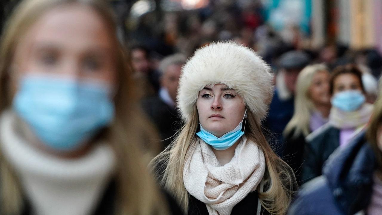 Shoppers buy Christmas presents on Oxford St, London. Masks have been reintroduced in the UK and people are being encouraged to work from home amid the surge in cases. Picture: Niklas Halle’n/AFP