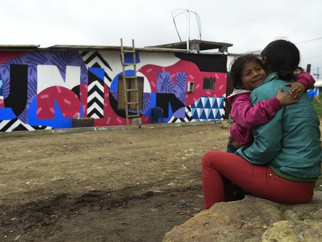 A victim of Colombia's armed conflict, Jessica Hernandez, sits with her daughter in an impoverished neighbourhood in Soacha municipality, south of Bogota, Colombia. Picture: AFP