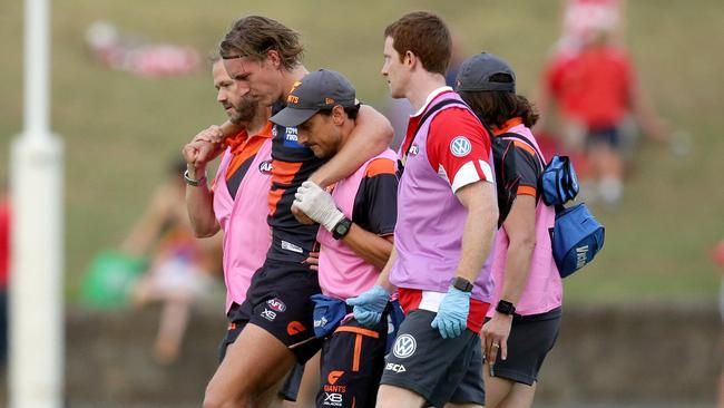 Will Setterfield is helped off the field after injuring his knee. Picture: Jonathan Ng