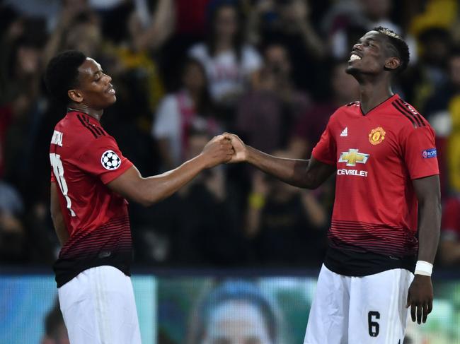 Manchester United's French midfielder Paul Pogba (R) and Manchester United's French striker Anthony Martial react after the UEFA Champions League group H football match between Young Boys and Manchester United at The Stade de Suisse in Bern on September 19, 2018. (Photo by Fabrice COFFRINI / AFP)