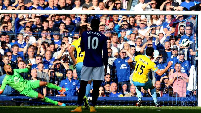 Mile Jedinak tucks away a spot kick against Everton.