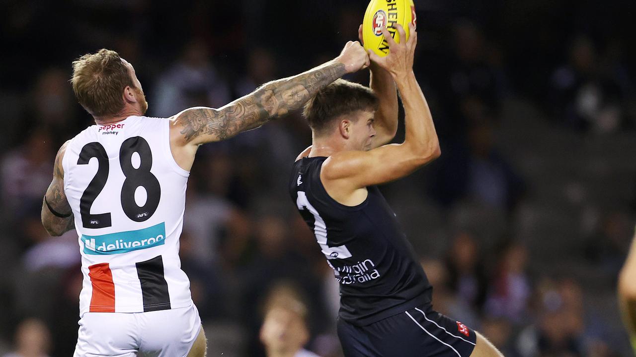 Paddy Dow goes back with the flight to mark against St Kilda.