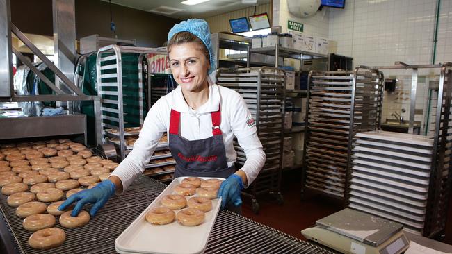 Keti Lozanoski hand-picking the dozens of glazed doughnuts. Picture: Carmela Roche