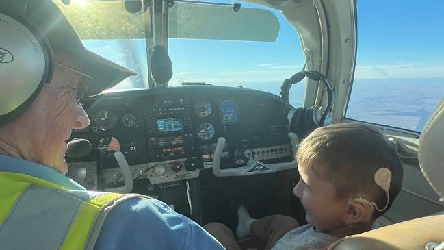 A volunteer pilot and a child on their way to receive treatment. Photo: Angel Flight Australia.