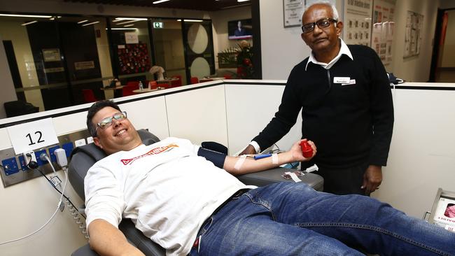 <i>Southern Courier</i> editor Antony Field gives blood with the help of blood technician Nooruddin Ahmad at the Australian Red Cross Hunter St blood donor centre in Sydney CBD. Picture: John Appleyard