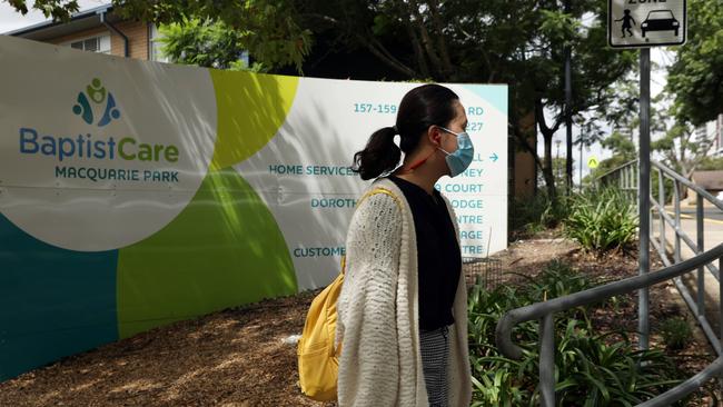 A woman walks past the Dorothy Henderson Lodge in Marsfield where an elderly resident died of coronavirus. Picture: Jane Dempster/The Australian.