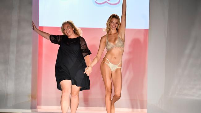 Sports Illustrated swimsuit edition editor MJ Day and a model walk the runway during SWIMMIAMI Sports Illustrated Swimsuit 2018 Collection in Florida. (Pic: Frazer Harrison/Getty)