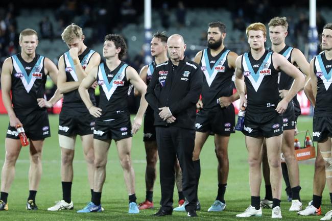 Port Adelaide players stand with coach Ken Hinkley as the Showdown 46 medal is presented at Adelaide Oval. Picture Sarah Reed