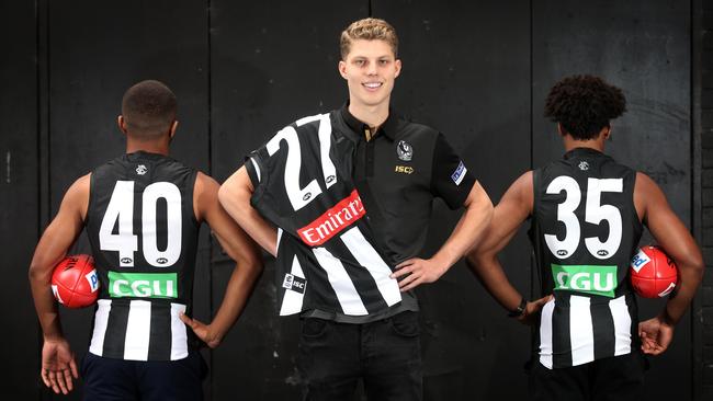 Collingwood's three draftees Will Kelly, Isaac Quaynor and Atu Bosenavulagi model off their new numbers. Picture: Michael Klein