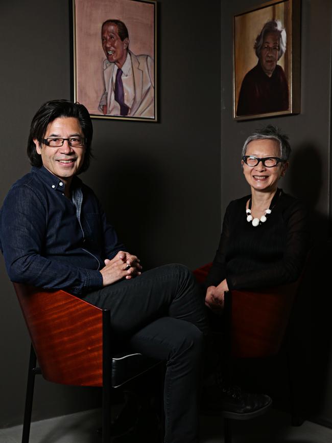 The couple at home with Les’ paintings of his parents in the background. Picture: Adam Yip