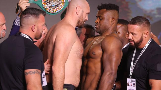 Britain's Tyson Fury (L) and Cameroonian-French Francis Ngannou go head to head during their weigh-in on the eve of their bout in Riyadh on October 27, 2023. (Photo by Fayez NURELDINE / AFP)