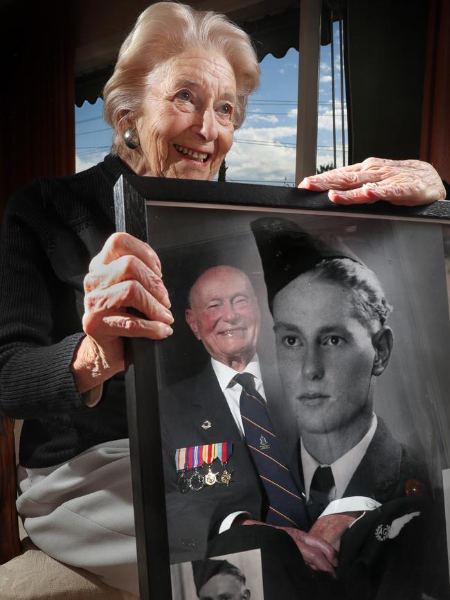 Jack's wife Dolores holds his framed image of himself aged 23, taken in 1941, when he was stationed in Egypt. Picture: Alex Coppel.