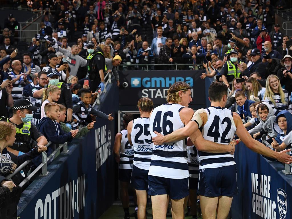 Mark Blicavs and Mark O'Connor of the Cats exit the field.