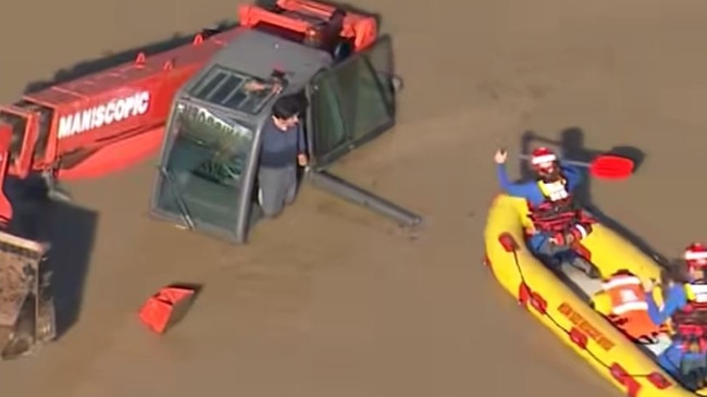 SES volunteers rescue a man trapped in an excavator at Erskine Park. Picture: 9NEWS